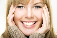 Woman with her face in her hands smiling